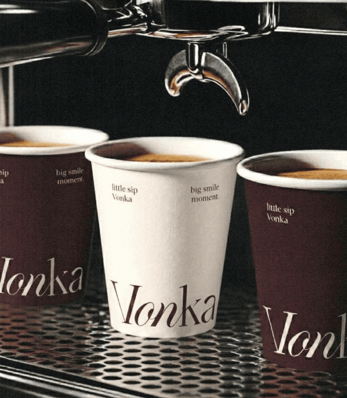 Vonka coffee cups beneath an espresso machine.